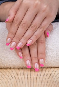 Beauty treatment photo of nice manicured woman fingernails. Very nice pink French manicure with silver detail.