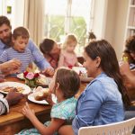 Family and friends sitting at a dining table